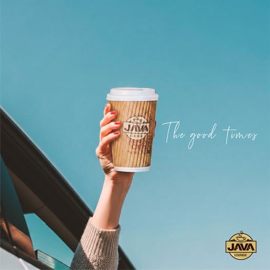 A Java Lounge cup raised to a clear blue sky